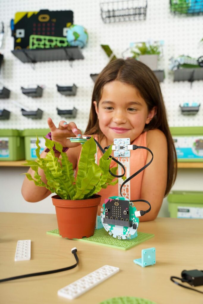 Female student testing the Pollinator counter project from the micro:bit Climate Action Kit