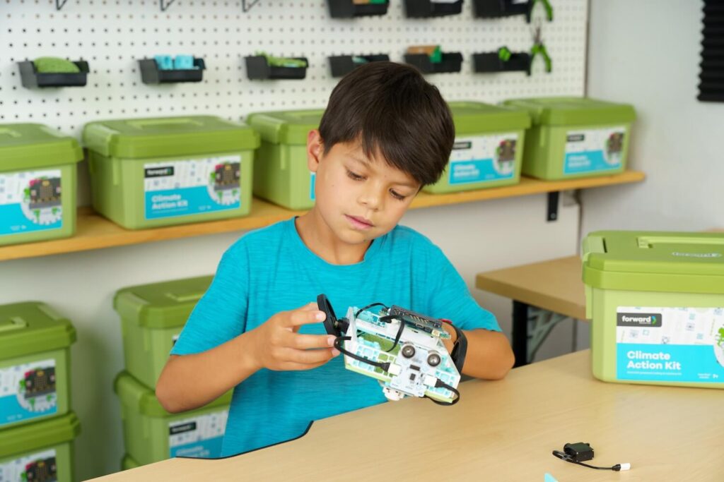 Male student building the micro:bit Electric Vehicle project from the Climate Action Kit