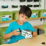 Male student building the micro:bit Electric Vehicle project from the Climate Action Kit
