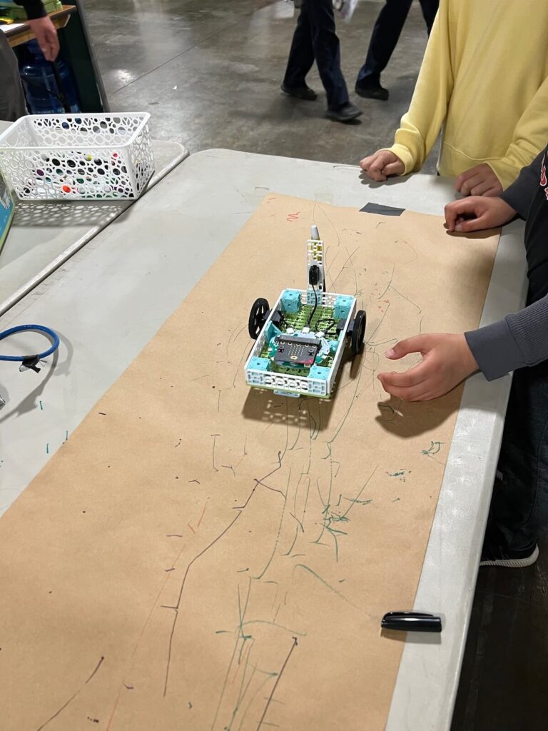 Students testing the micro:bit Tree Seeder project in the Climate Action Kit