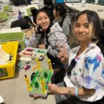 Two female students working on the micro:bit Tree Seeder project in the Climate Action Kit