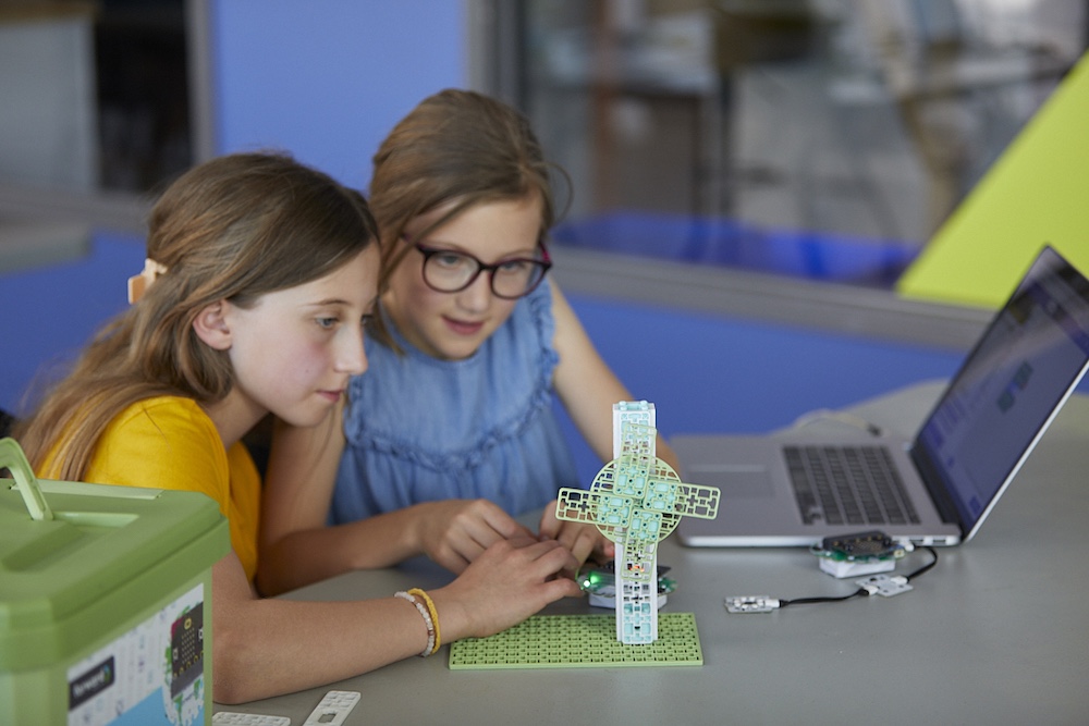 Two girls sitting at a desk working on the Wind Turbine project from the Climate Action Kit
