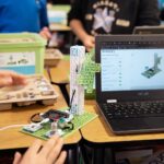 Wind Turbine project from the Climate Action Kit sitting on a desk beside a laptop