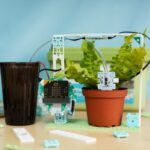 Smart Farming project from the Climate Action Kit showing a micro:bit, plant, and cup of water