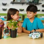 Two students looking at various micro:bit projects from the Climate Action Kit