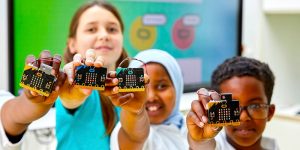 Kids holding BBC micro:bit