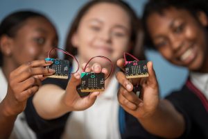 kids holding BBC micro:bits