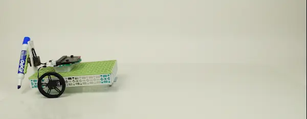 A gif of Forward Education's completed tree seeding vehicle. A finger presses a button, and the vehicle begins driving from left to right. As the vehicle drives, a marker attached to the back draws four equal marks on the ground.
