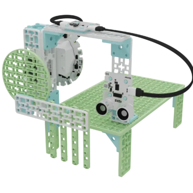 Animal crossing prototype build with the Climate Action Kit components. The base plate is elevated with the 4 short green frames to create a tunnel and an overpass. There is an entry to the bridge where the sonar sensor, solar sensor, and breakout board are attached. There is a gate to the tunnel that is attached to a positional servo motor.