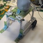 Real build of mobile irrigation vehicle on teacher desk.
