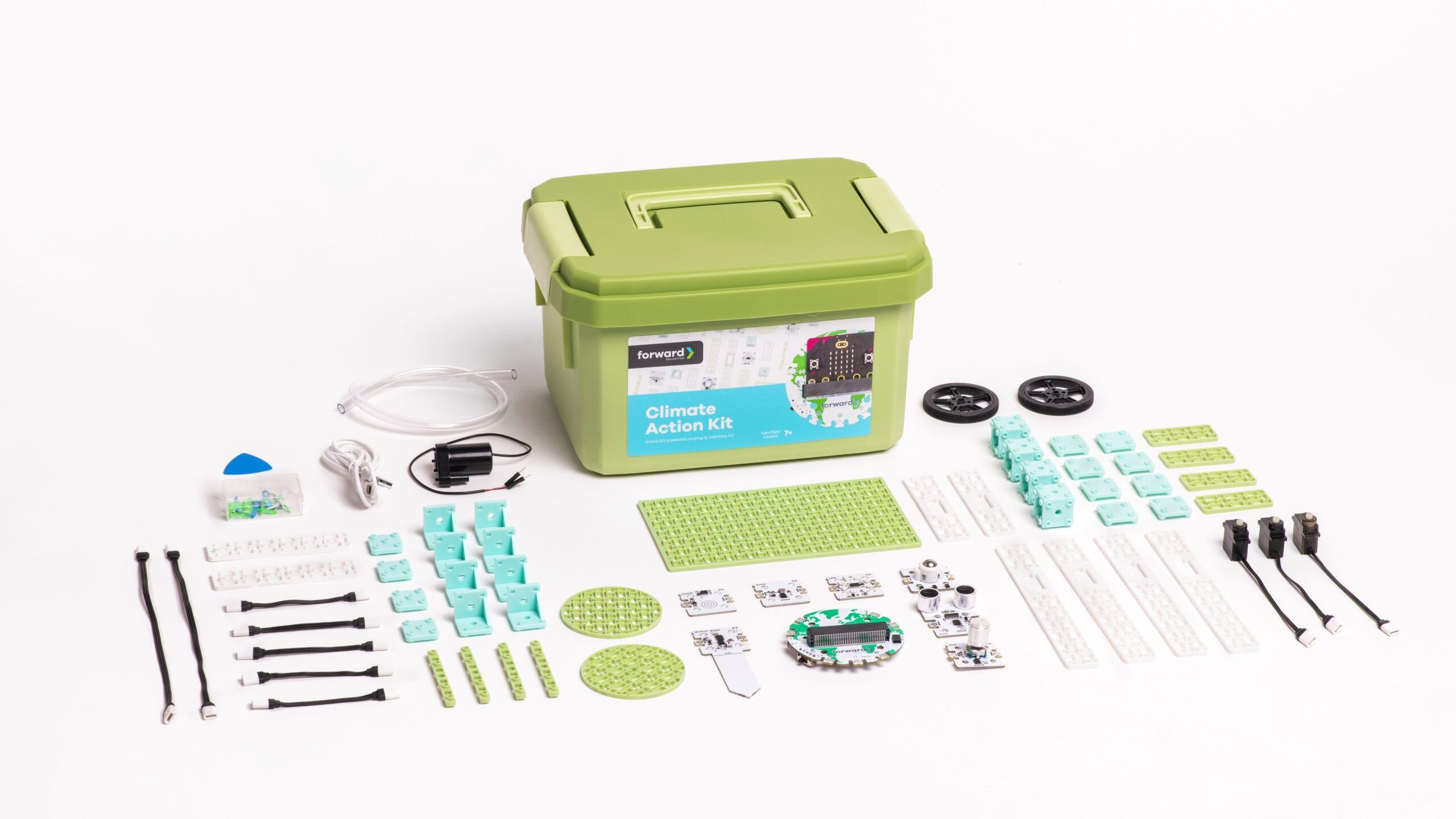 Image of the Climate Action Kit, featuring a green storage container labeled 'Climate Action Kit' surrounded by its contents. The kit includes various components such as a breakout board, sensors, motors, wheels, cables, and building blocks.
