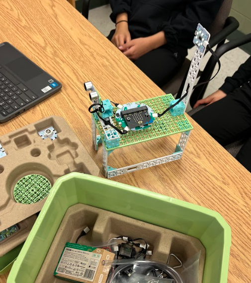 Completed build of the Hope Spot Station project sits on a student's desk among other pieces of the Climate Action Kit.