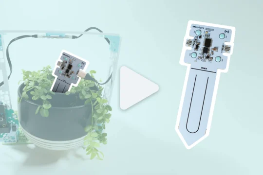 A highlighted moisture sensor in a project with a flower beside an enlarged moisture sensor with a large video play button in the centre.