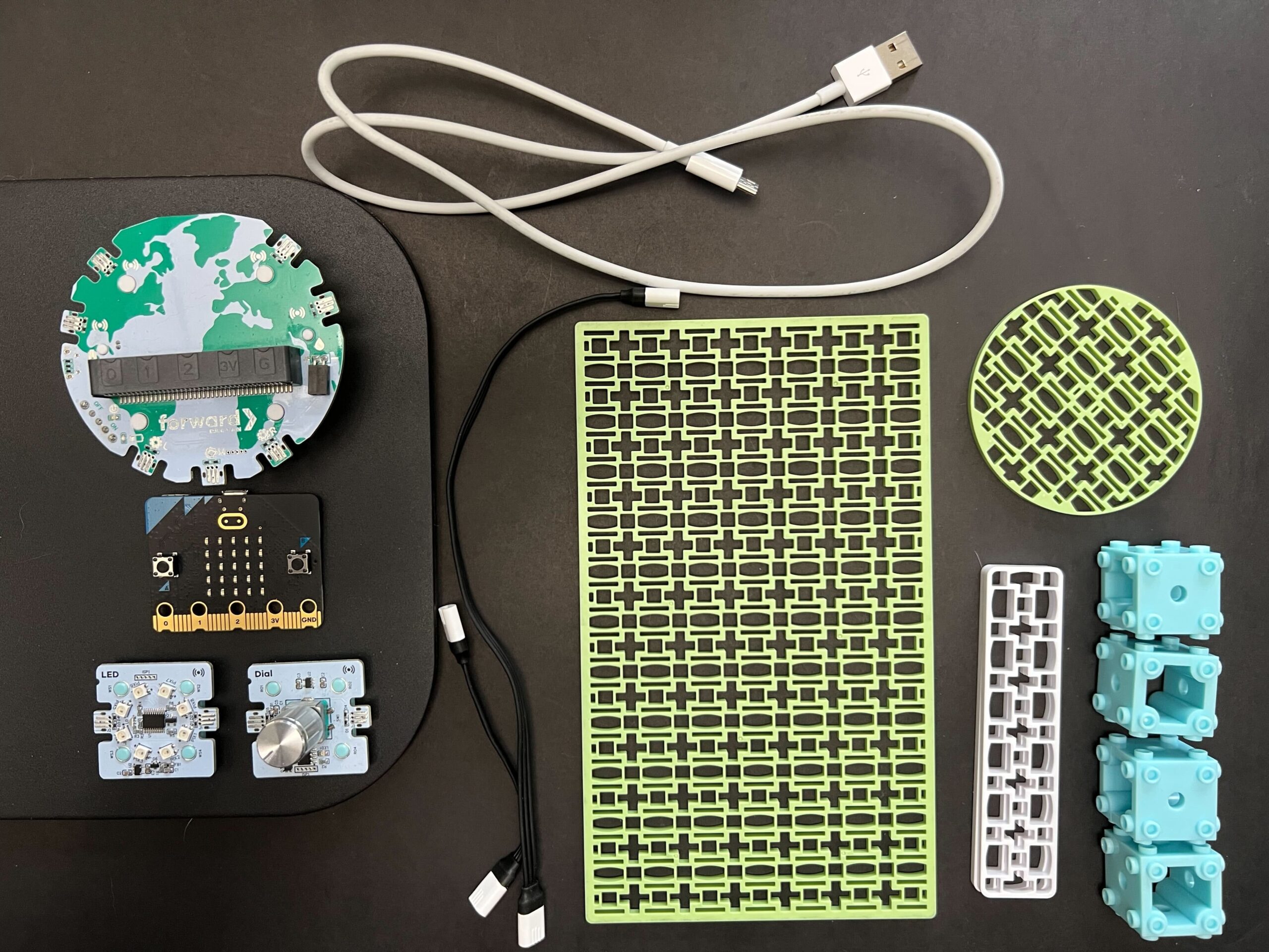 Image showing components of the Climate Action Kit arranged neatly on a black surface.
