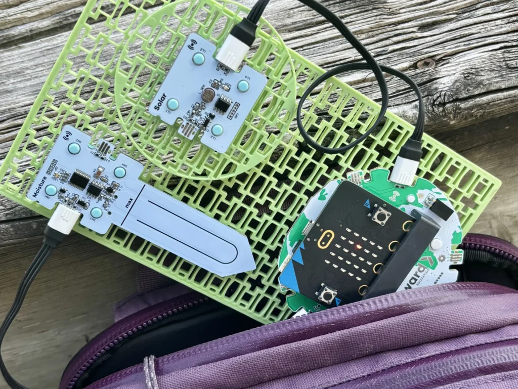 Forward Education's habitat monitoring project build indoors coming out of a backpack