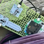 Forward Education's habitat monitoring project build indoors coming out of a backpack