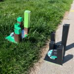 Custom model cities/parks used in Urban Heat Island experiment conducted outdoors. The green park is placed on grass. The dark city model is placed on cement.