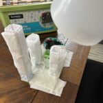 Base model city build plus damp, white paper towel coverings for Eliminating Urban Heat Islands experiment. Incandescent lamp acts as a heat/light source above the model.