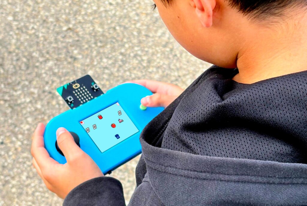 A young child plays Recycle Rush on a CodeCTRL device.