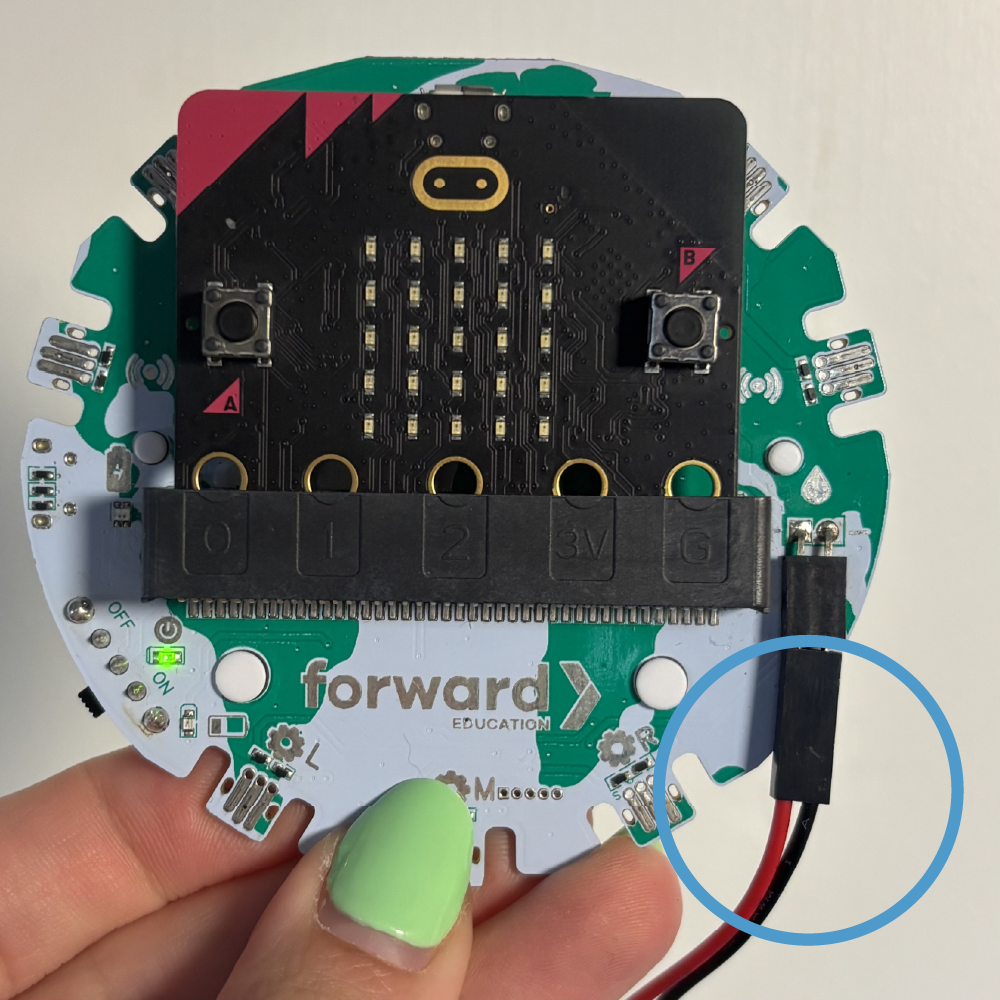 A circled set of wires, with the red wire on the left, and the black wire on the right