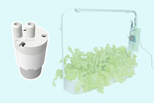 Thumbnail. Picture of peristaltic pump next to hydroponics setup which is growing lettuce.