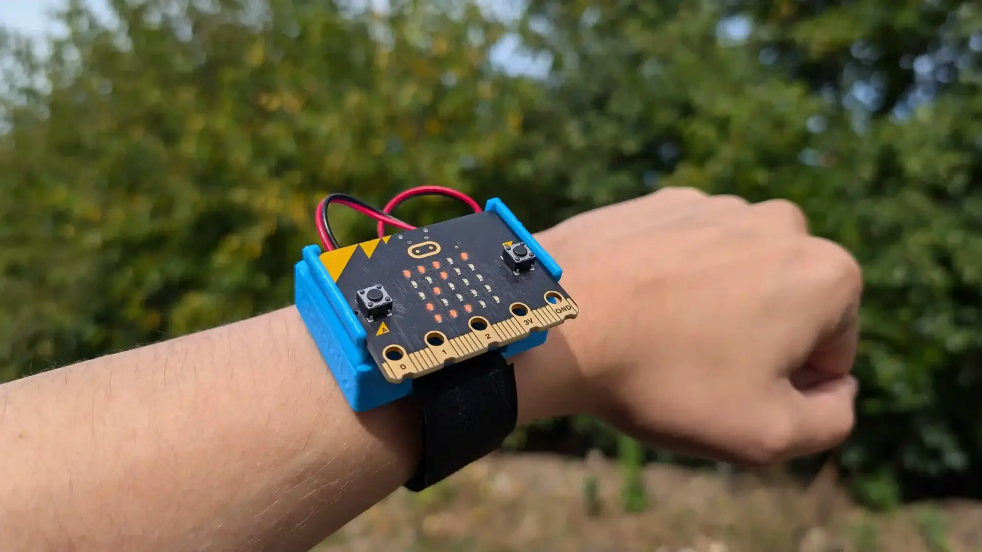 CHARGE for micro:bit attached to a wrist displaying 2 degrees.